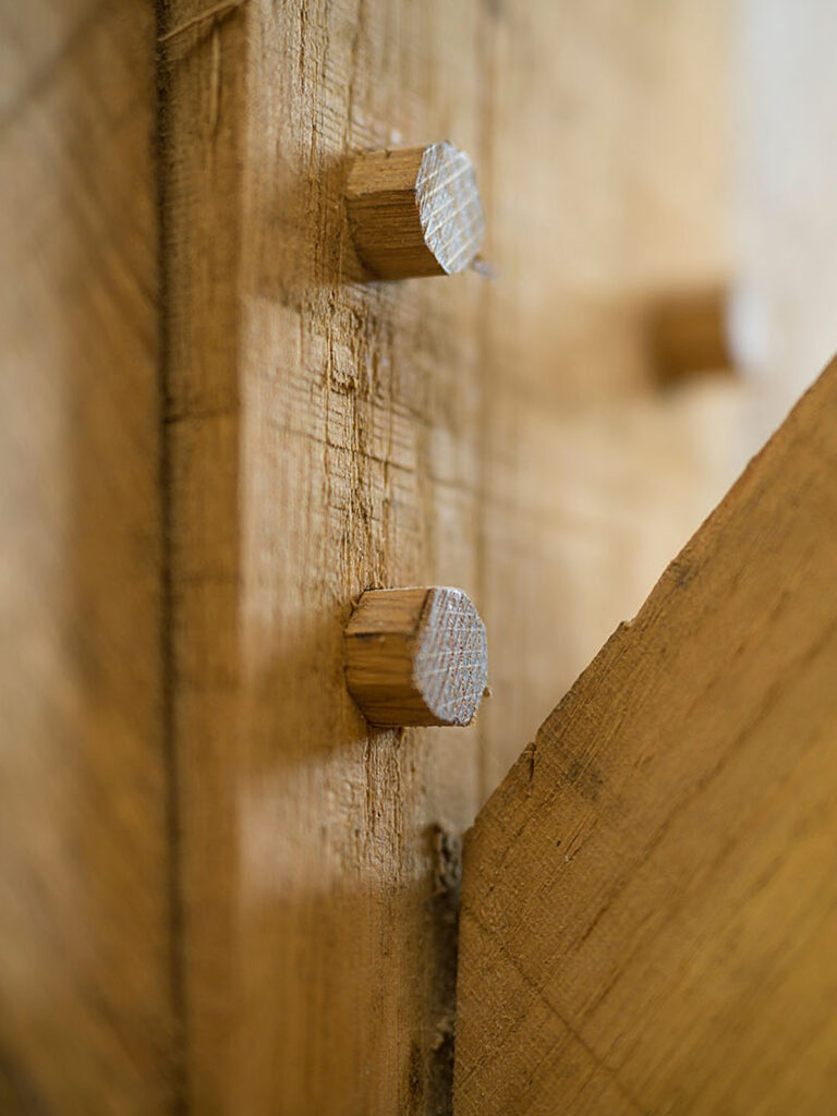 OSPIN Design and Build close up detail of an oak frame joint with wooden pegs