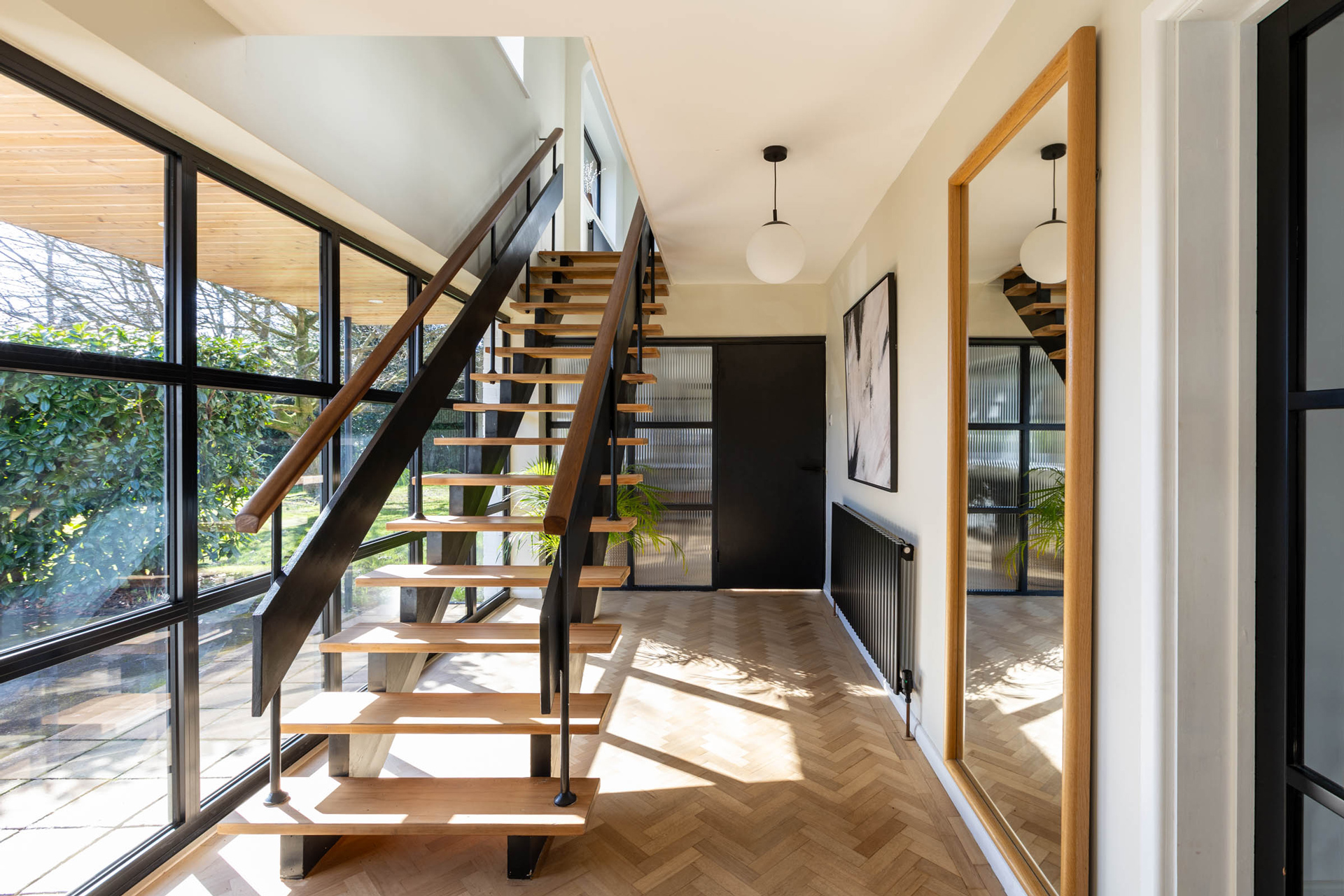 OSPIN Design and Build interior hero image with a contemporary interior hallway with large glazing