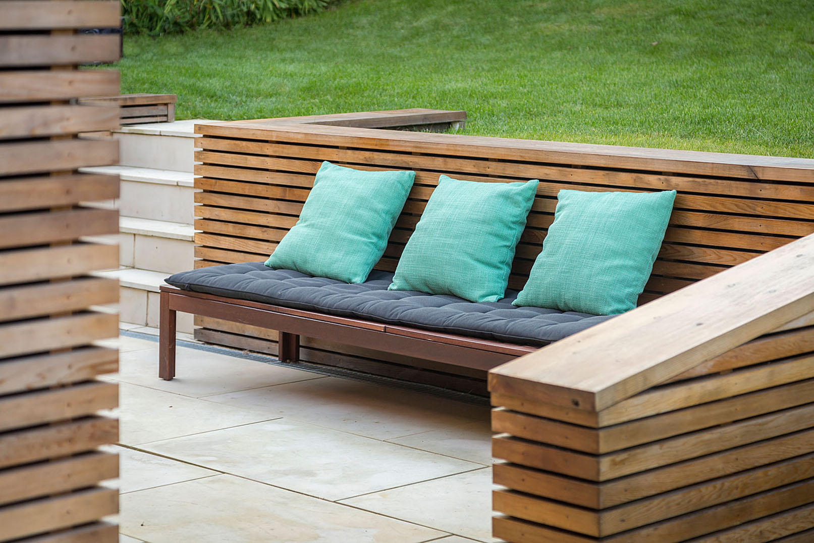 The sloping garden was reshaped to create new terraces and seating areas, strengthening the connection between the interior and outdoor spaces while supporting everyday family living and entertaining.