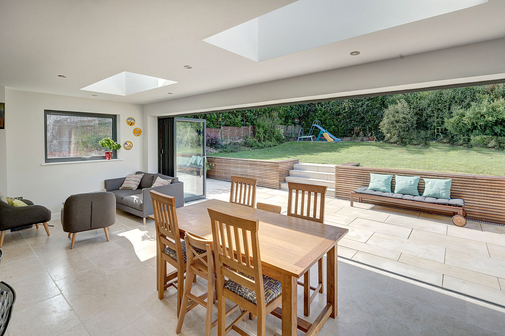A single-storey extension forms a generous open-plan kitchen and dining space with large bi-folding doors and rooflights bringing natural light deep into the home.