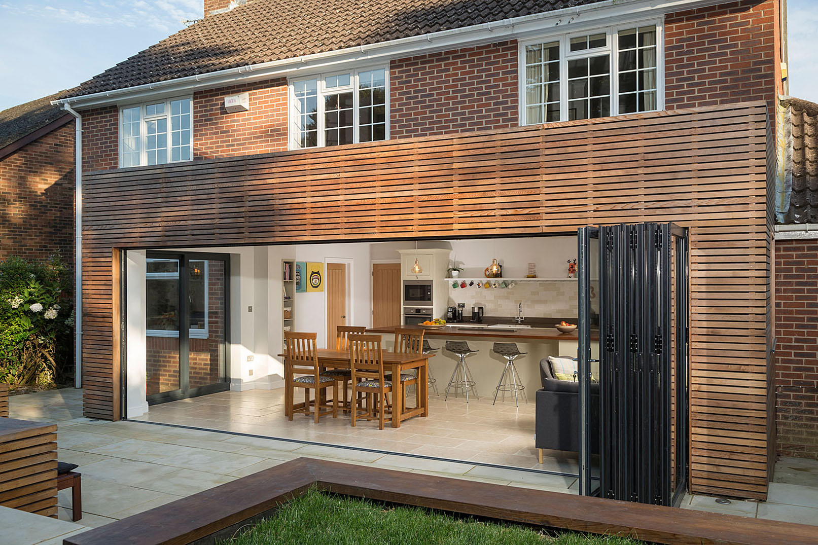 A single-storey extension forms a generous open-plan kitchen and dining space with large bi-folding doors and rooflights bringing natural light deep into the home.