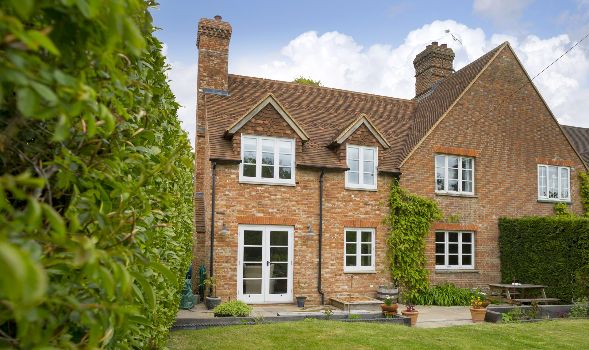 The extension continues the rhythm and proportions of the existing architecture through the use of pitched roof forms, traditional detailing and carefully considered material choices.