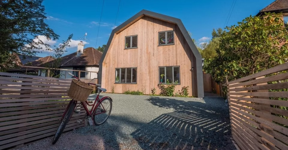 The Nook transforms a dated 1950s bungalow in Forest Row into a contemporary Dutch barn-inspired family home.