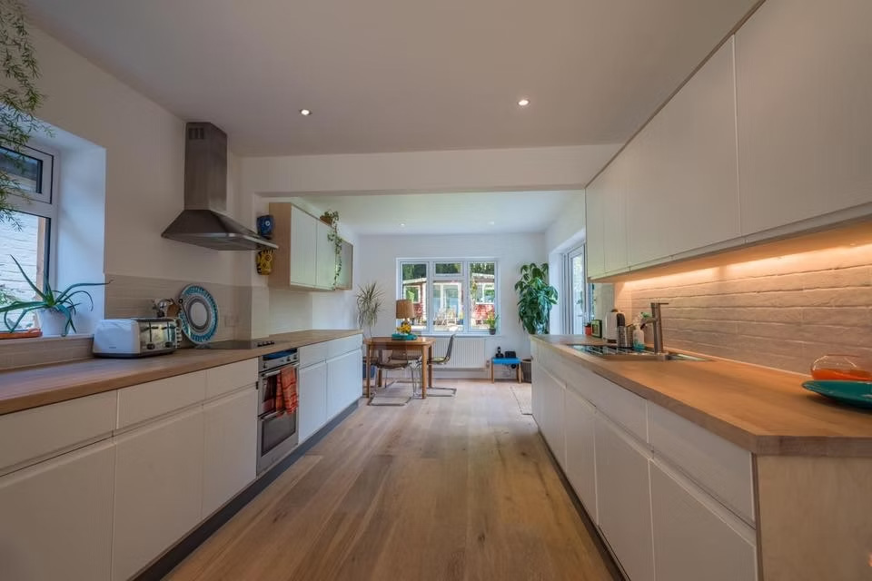 Rather than extending outwards, the design reworks the existing roof form to create a full first floor within the original footprint, preserving the garden and neighbouring views.