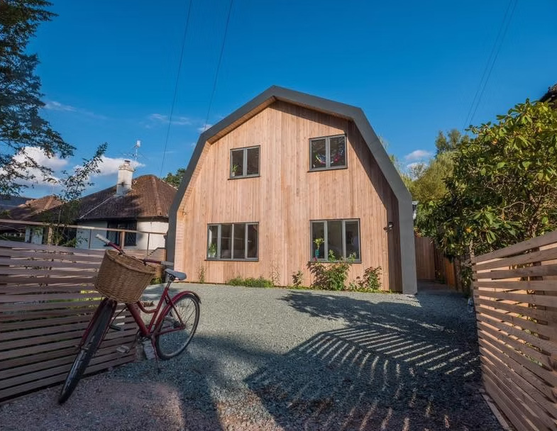 The Nook transforms a dated 1950s bungalow in Forest Row into a contemporary Dutch barn-inspired family home.