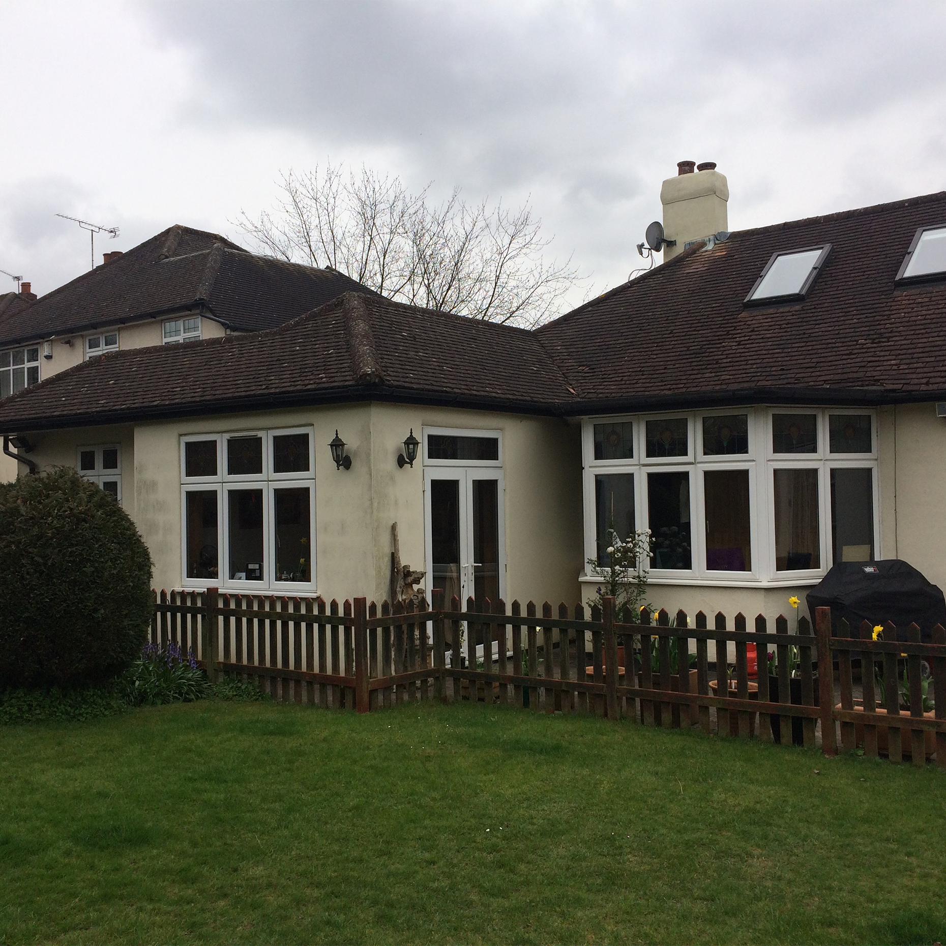 Surrey bungalow conversion and double-storey extension by OSPIN, transforming an existing home with modern architecture, open-plan living and a contemporary white timber-clad exterior.